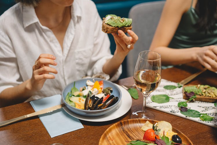 Woman Eating Avocado Toast At A Restaurant