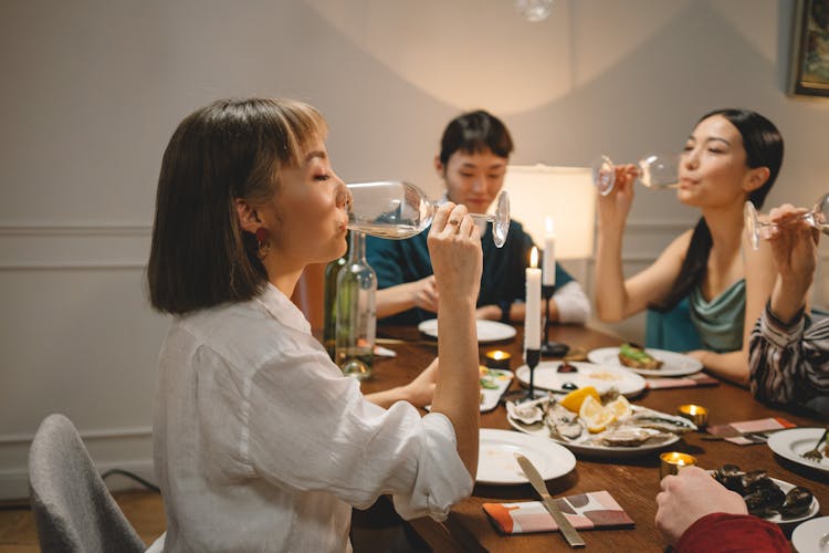 A Group Of Friends Drinking Wine At A Dinner