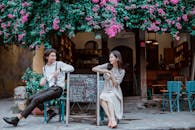 A Couple Leaning on a Menu Board