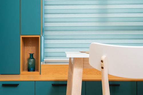 Free Decorative vase on wooden shelf of cabinet against table and chair in contemporary light house kitchen Stock Photo