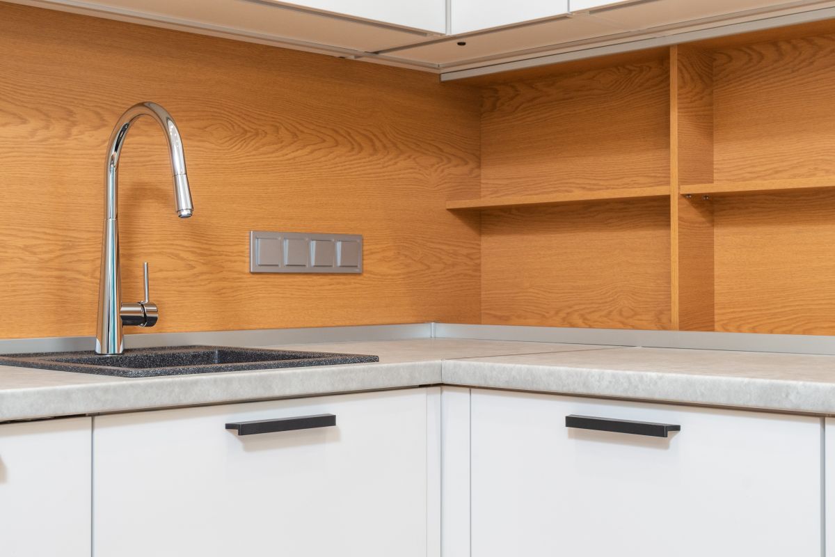 Modern kitchen cabinet with stainless steel sink showing tidy under-sink storage potential
