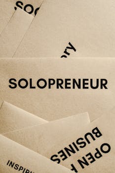 Minimalist solopreneur business cards laid out conceptually in a creative stack.