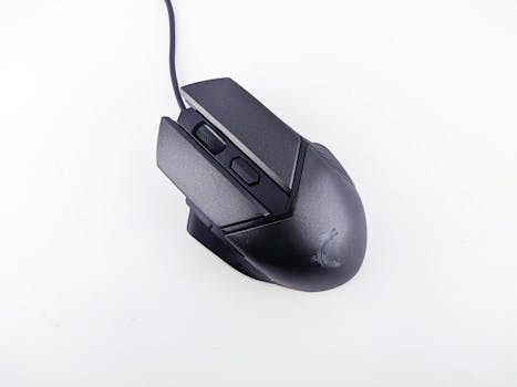 Close-up of a sleek black ergonomic gaming mouse with cable on a white background.