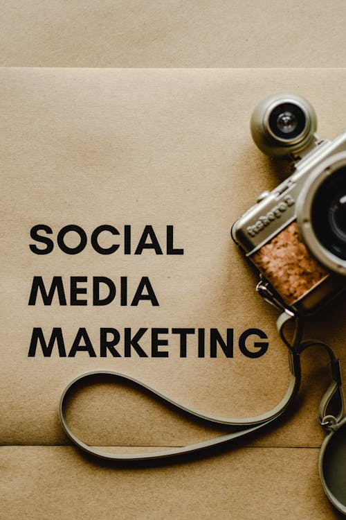 Free Close-Up Shot of a Social Media Marketing Text on an Envelope beside a Digital Camera Stock Photo