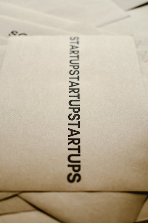 Free Close-Up Shot of a Startup Text on a Brown Paper Stock Photo