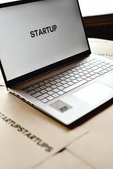 Modern laptop with startup text on screen, ideal for business themes.