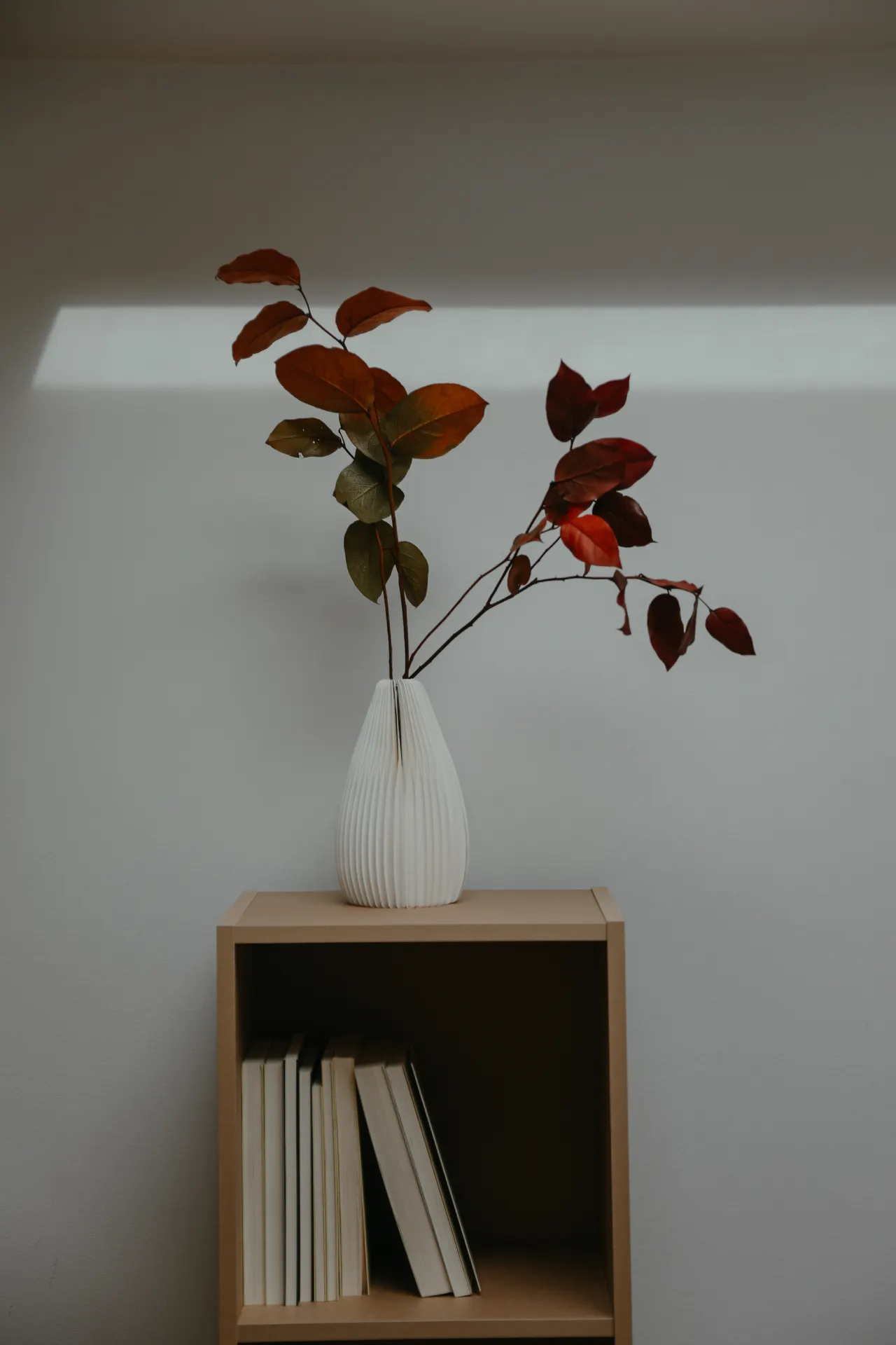 groups-of-three-shelf-styling Small group of vase and stacked books styled together on a wooden cube shelf