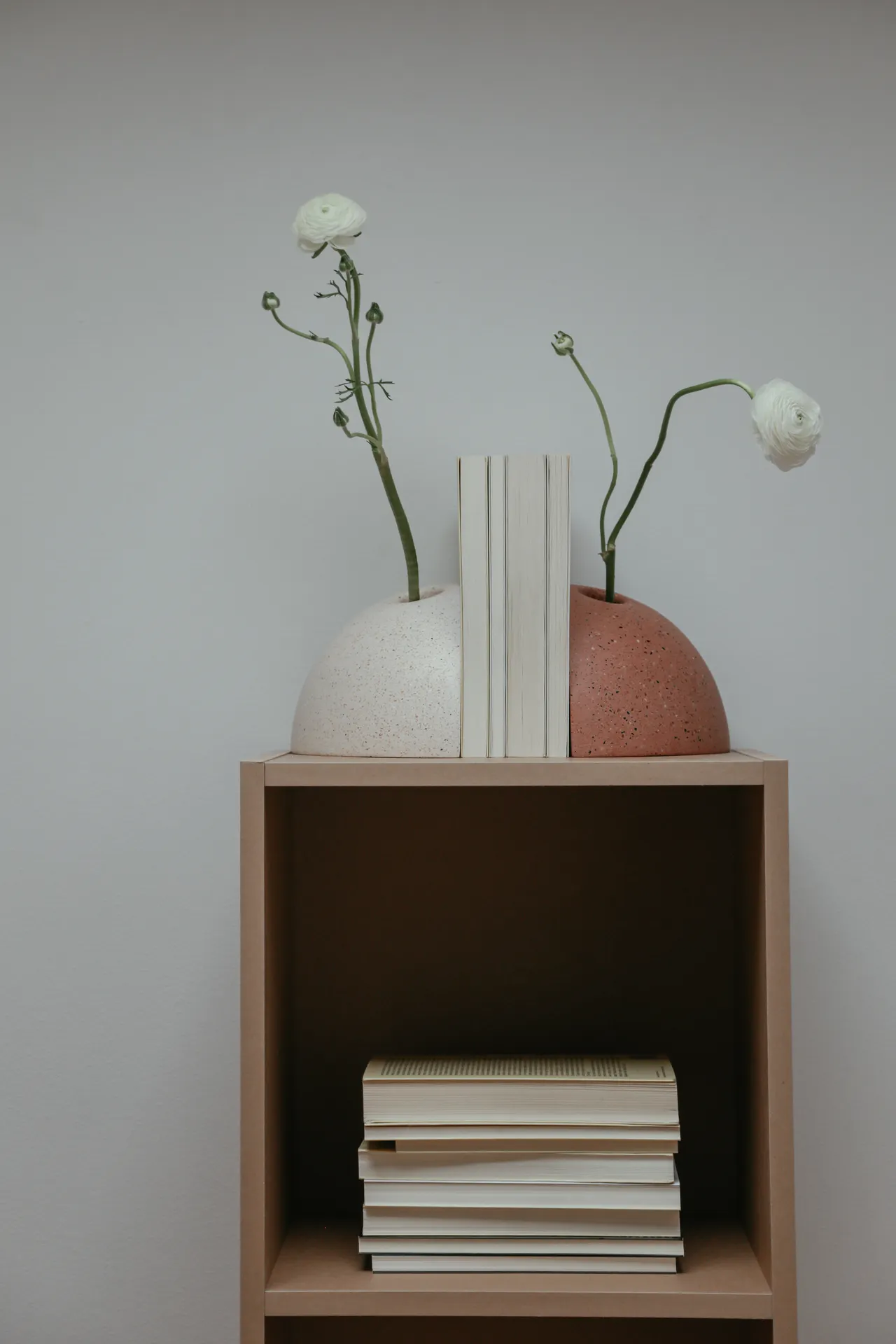 repeat-colors-bookshelf-styling White cube shelf with matching white vases and neutral books in a repeated palette