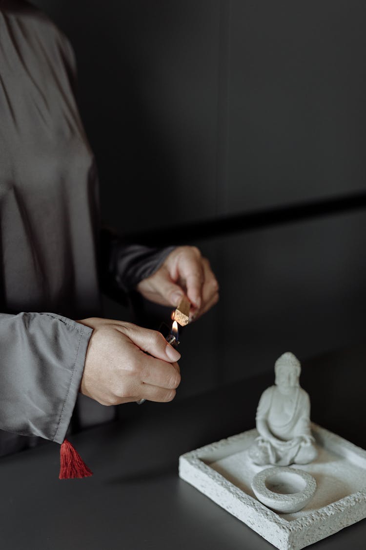 A Person Lighting A Palo Santo