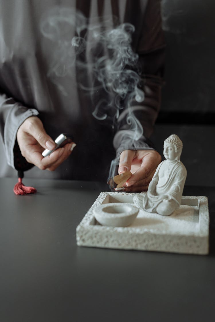 A Person Lighting A Palo Santo