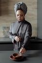 Woman in Gray Long Sleeve Shirt Standing Near Painting