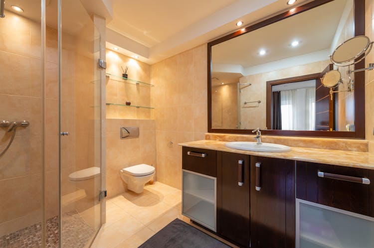 Modern Bathroom Interior With Shower Cabin Against Mirrors