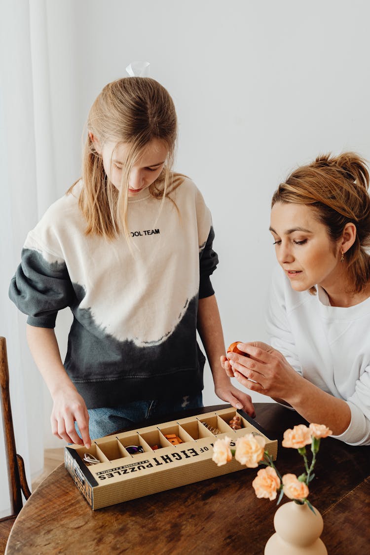 Mother And Daughter Opening A Puzzle