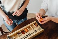 People Holding Parts of a Puzzle