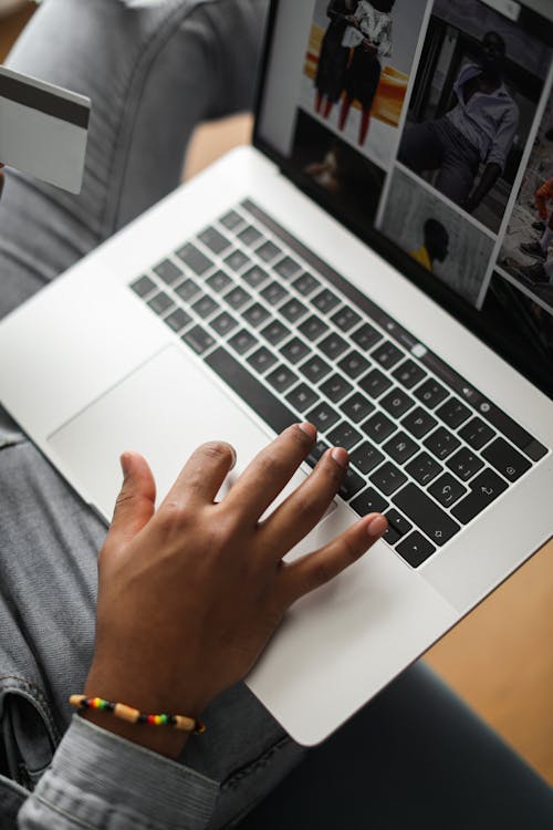 High-Angle Shot of a Person's Finger Using the Touchpad