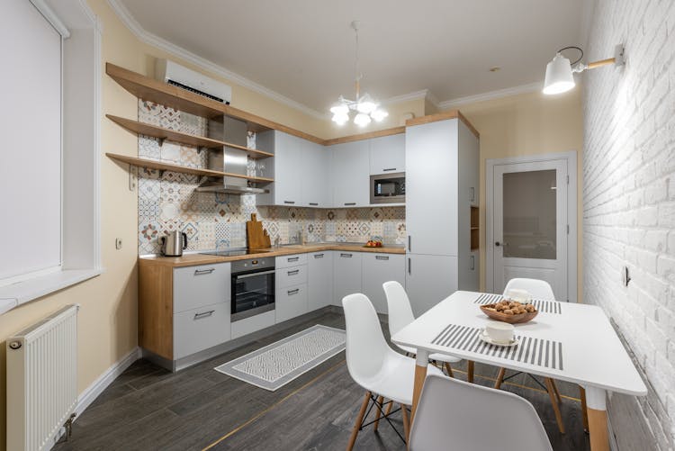 Kitchen Interior With Cabinet And Table Under Shiny Lamp