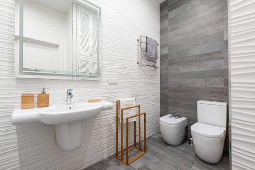 Contemporary bathroom interior with washbasin and toilet bowl