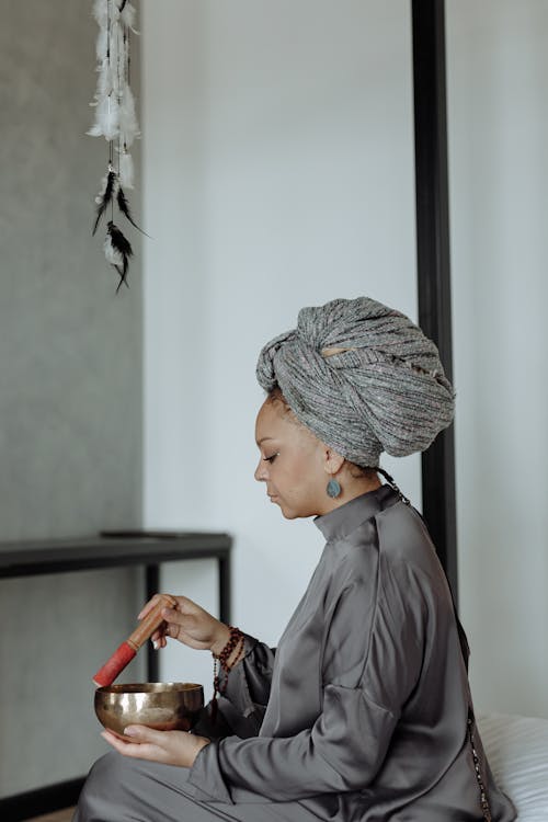 Focused Woman using Tibetan Singing Bowl 