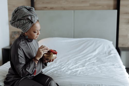 A Woman Meditating using a Tibetan Singing Bowl