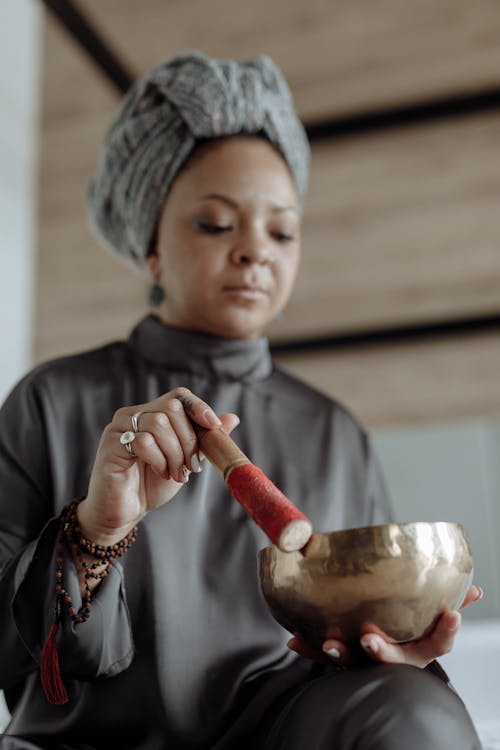 Free A Woman Using a Tibetan Singing Bowl Stock Photo