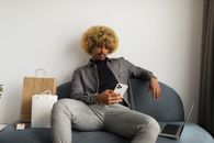 Woman in Gray Cardigan Sitting on White Chair