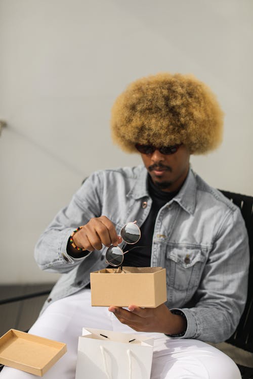A Man Holding a Box with Sunglasses 