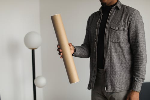 A Person Holding a Cardboard Tube