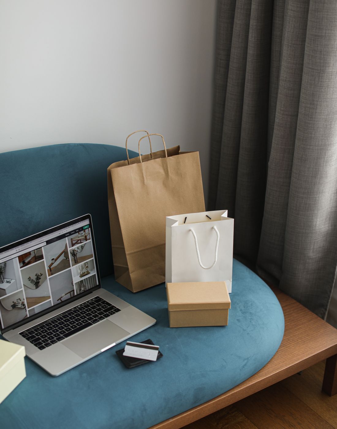 A laptop and shopping bags from a recent online order