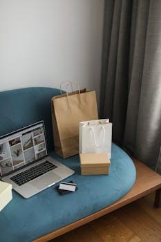 A cozy indoor scene featuring a laptop with shopping bags, representing modern online shopping.