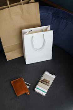 Modern online shopping setup with bags and smartphone.