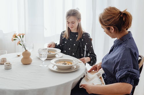 Free Women Sitting by a Dining Table Stock Photo
