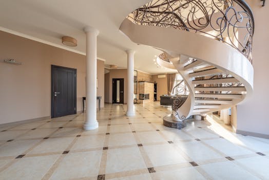 Beautiful spiral staircase in a spacious luxury interior with elegant decor and design.