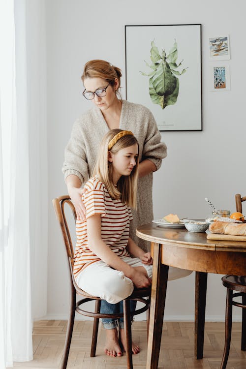 Free Woman Fixing Daughters Posture Stock Photo