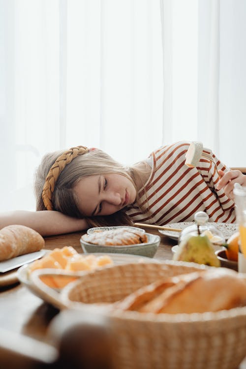 Free Unhappy Girl Having No Appetite at Breakfast Stock Photo