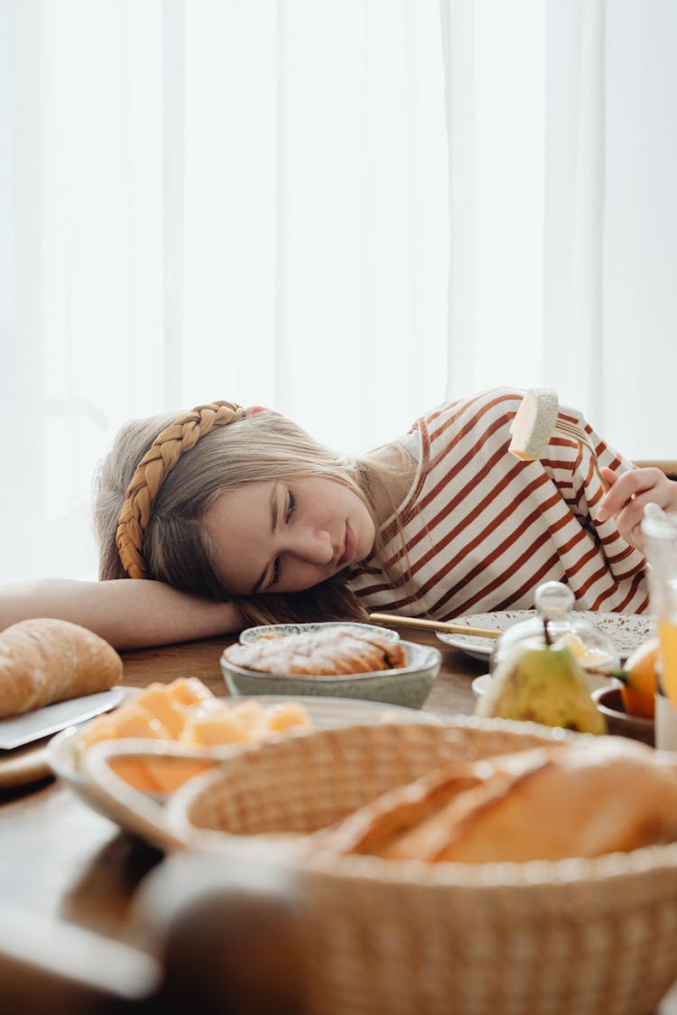 Unhappy Girl Having No Appetite At Breakfast 