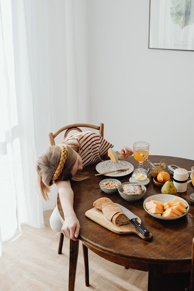 Teenager Sleeping On Wooden Table Top