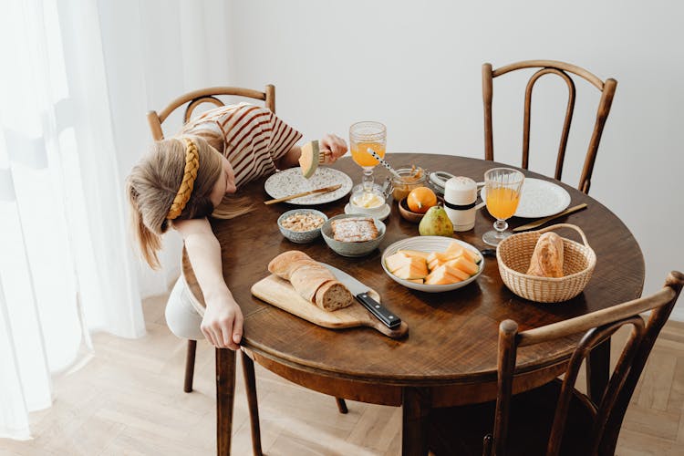 Teenager Sleeping On Wooden Table Top