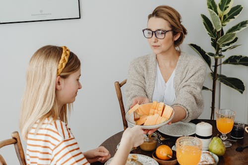 Mother and Daughter Taking Their Breakfast Together