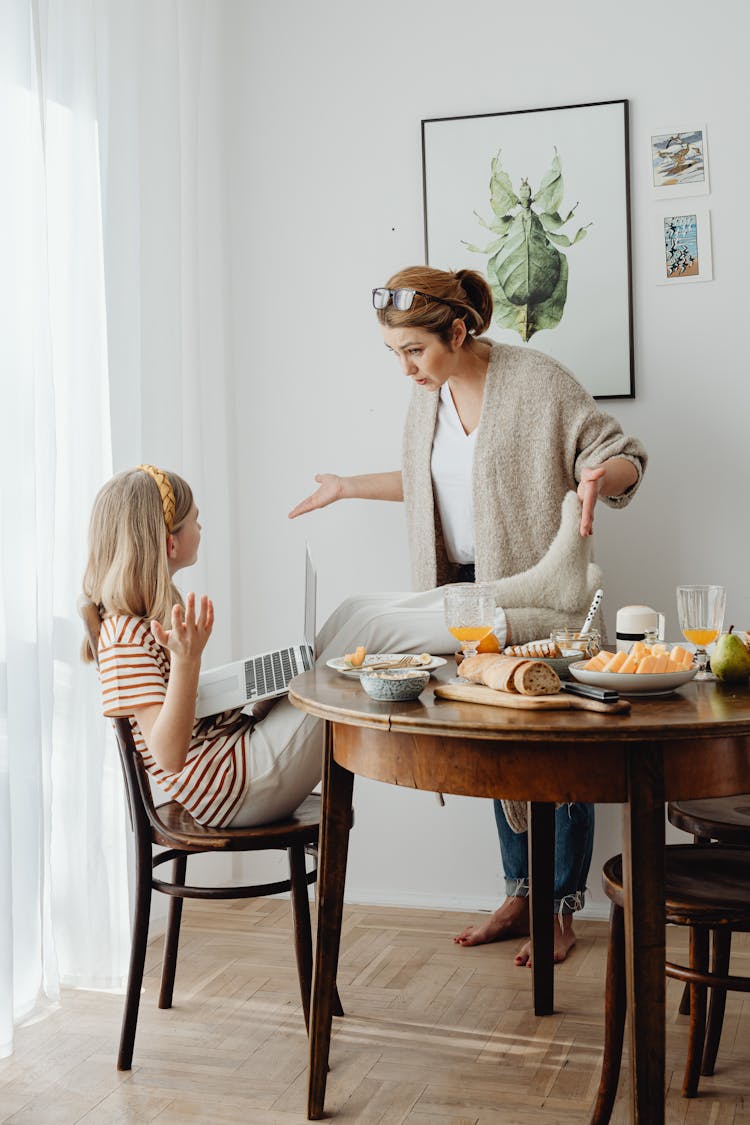 Mother Scolding Child For Bad Behavior At Table