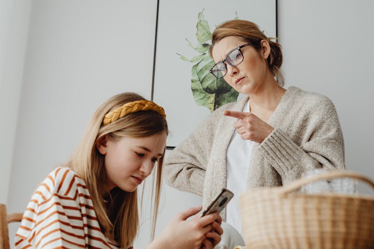 Mother Scolding Teenage Daughter Using Phone