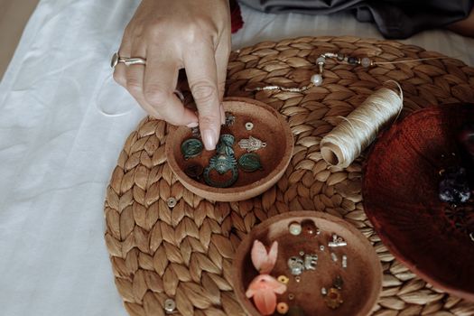 Hand of a Person on a Bowl of Accessories