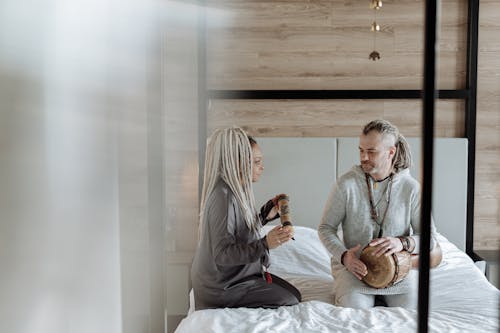 Couple Playing Music in Bed