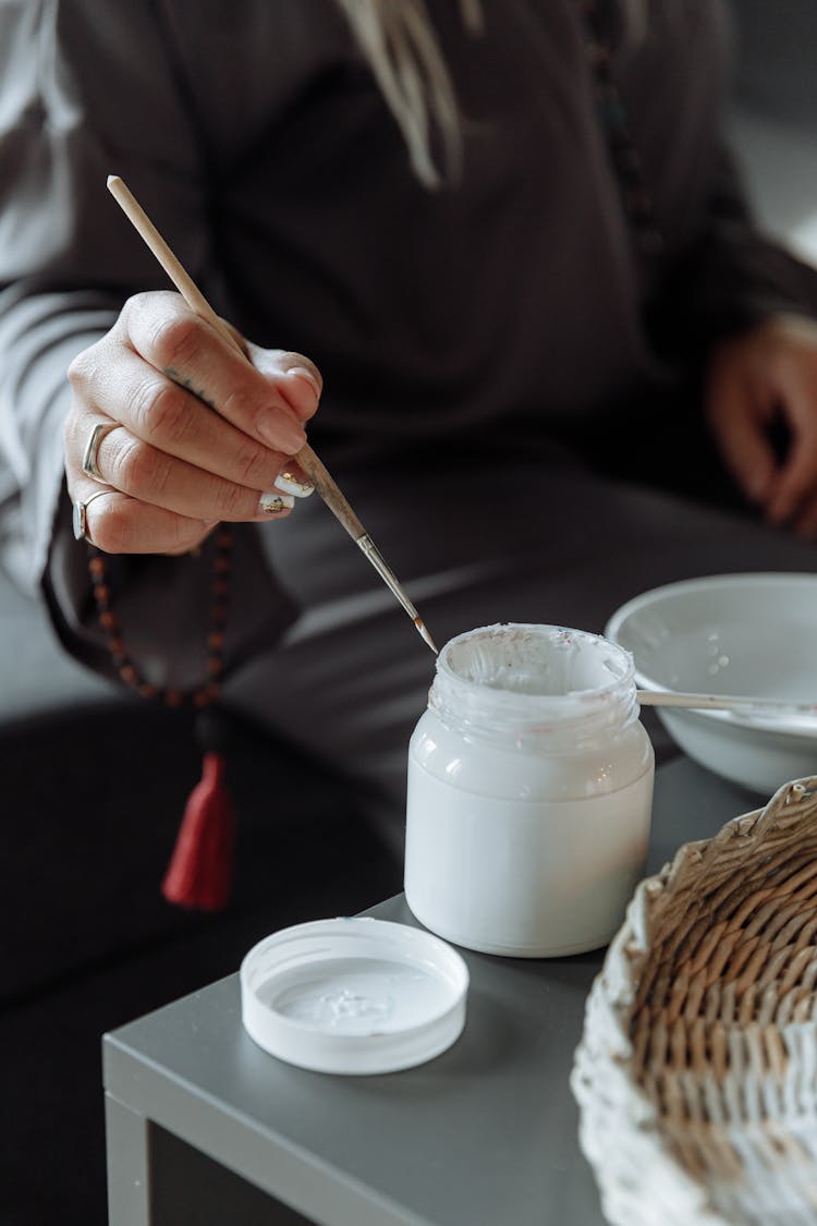 Woman Painting With Coconut Oil