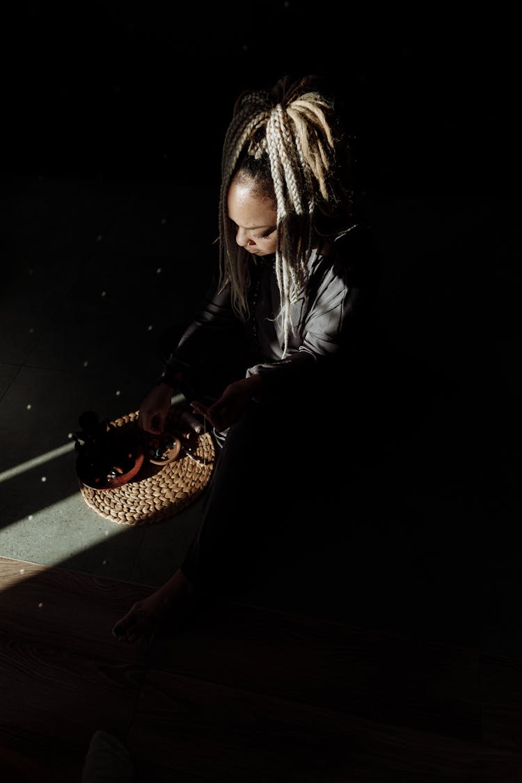 Woman Sitting In Shadow