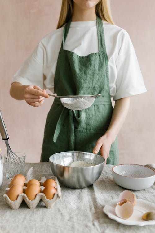 Free Person Holding a Strainer with Flour Stock Photo