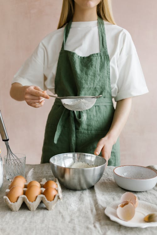 Person Holding a Strainer with Flour