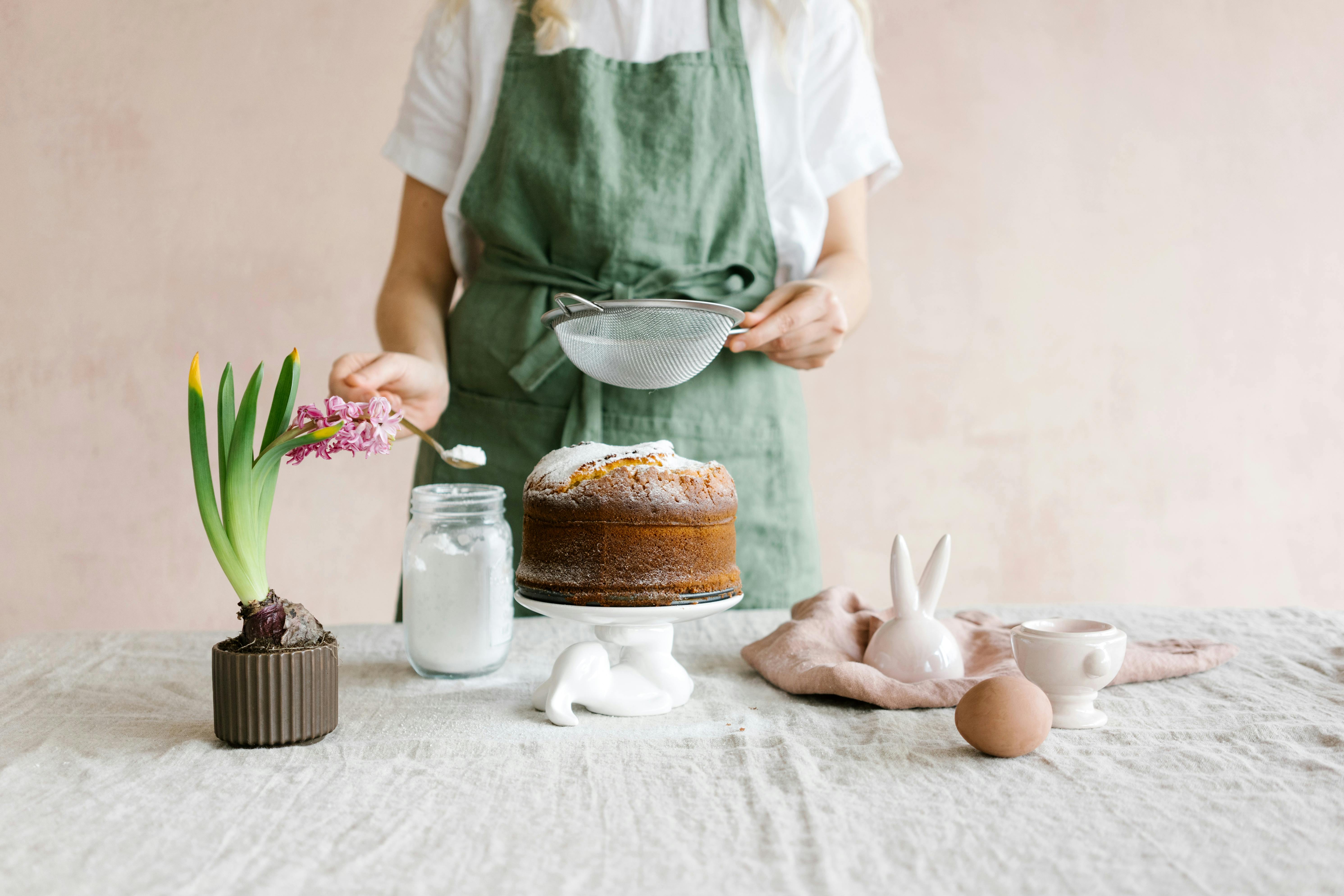 woman in white apron holding white plastic spoon