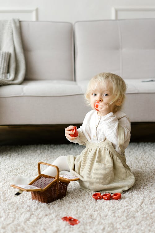 Little Girl Playing with Small Teacups