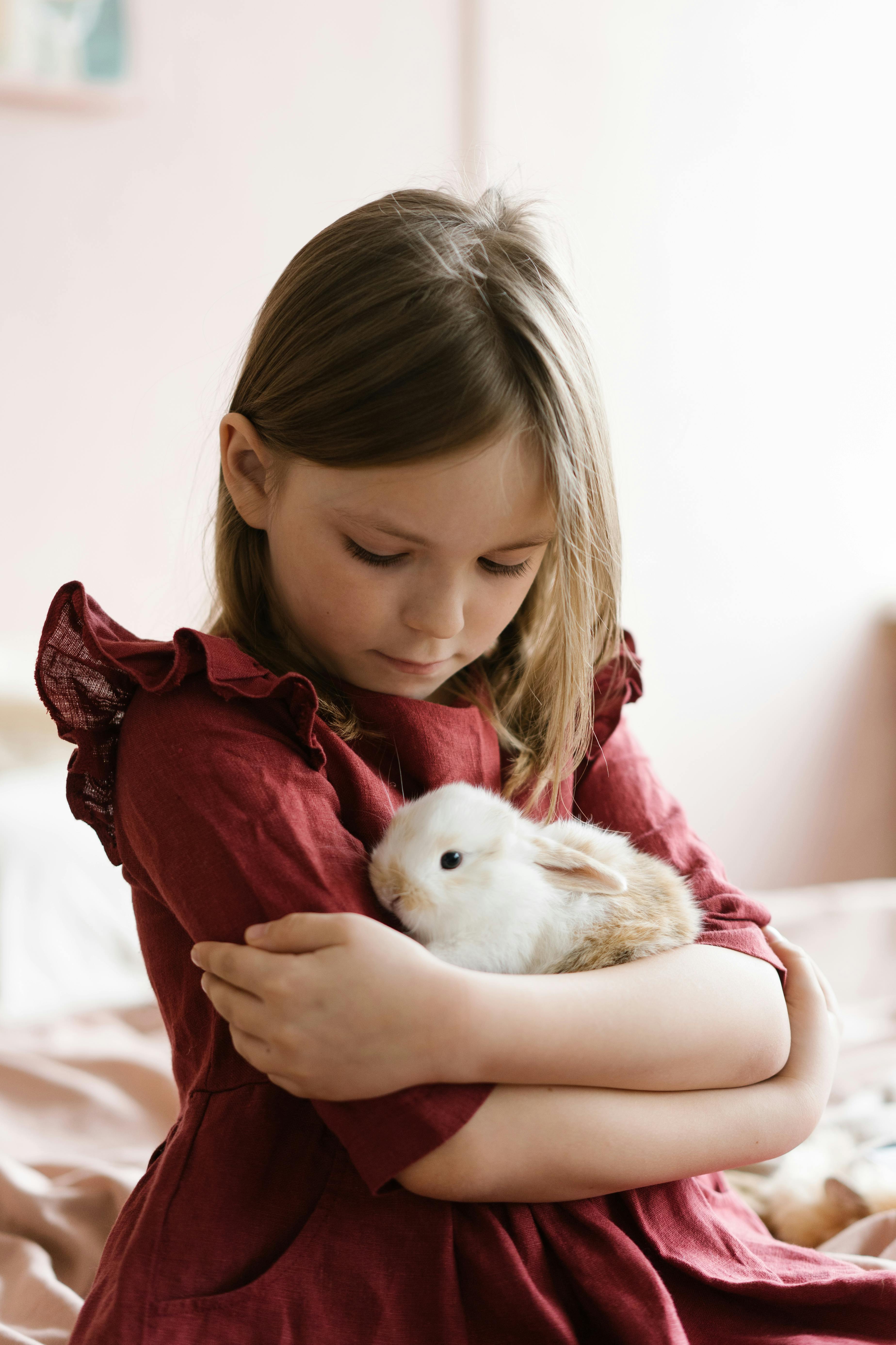 young girl hugging a rabbit