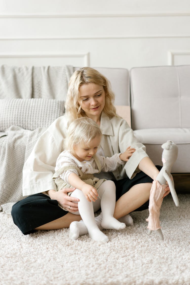 Woman And Child Playing With A Stuff Toy